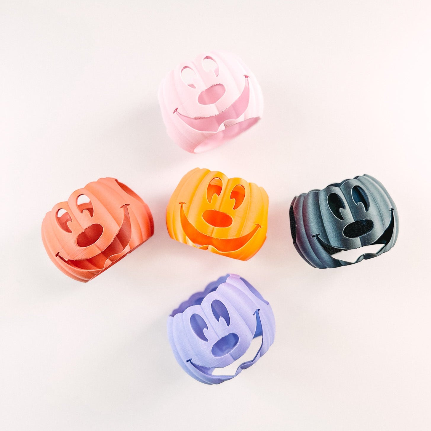 Five colorful plastic clips on a white background