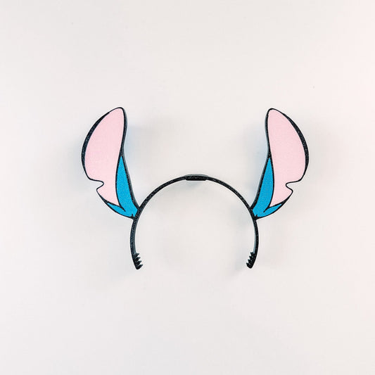 Headband with pink and blue rabbit ears on a white background
