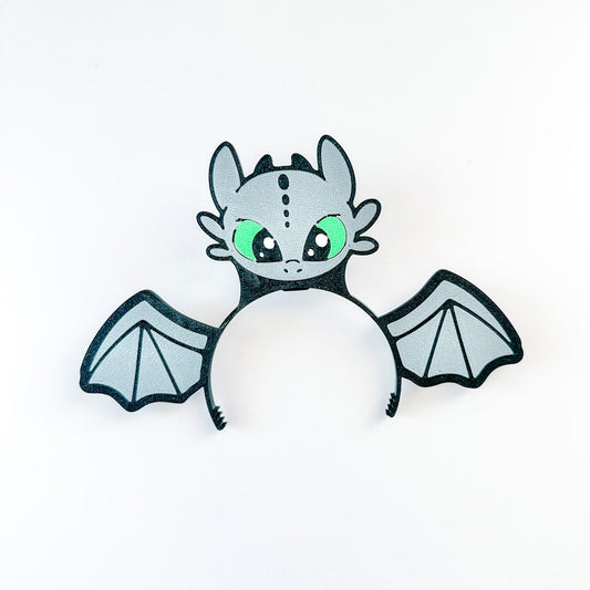 Cartoon dragon with green eyes on a white background