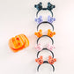 Set of colorful Halloween-themed hair ties on a white background