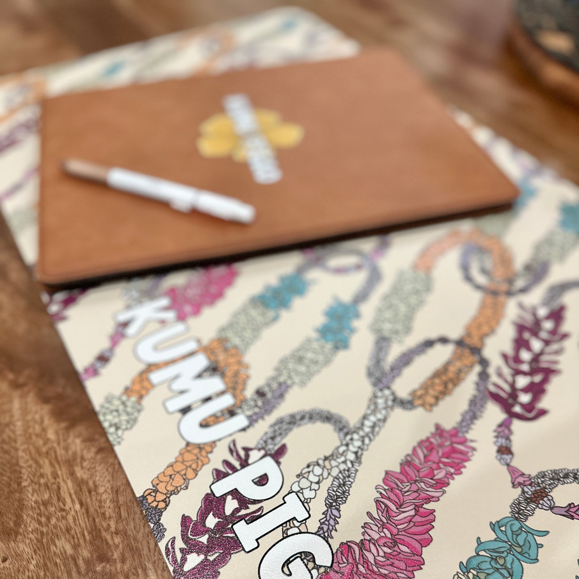 Colorful card with floral design and text on a wooden surface