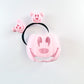 Pink hair accessory with a smiley face design on a white background