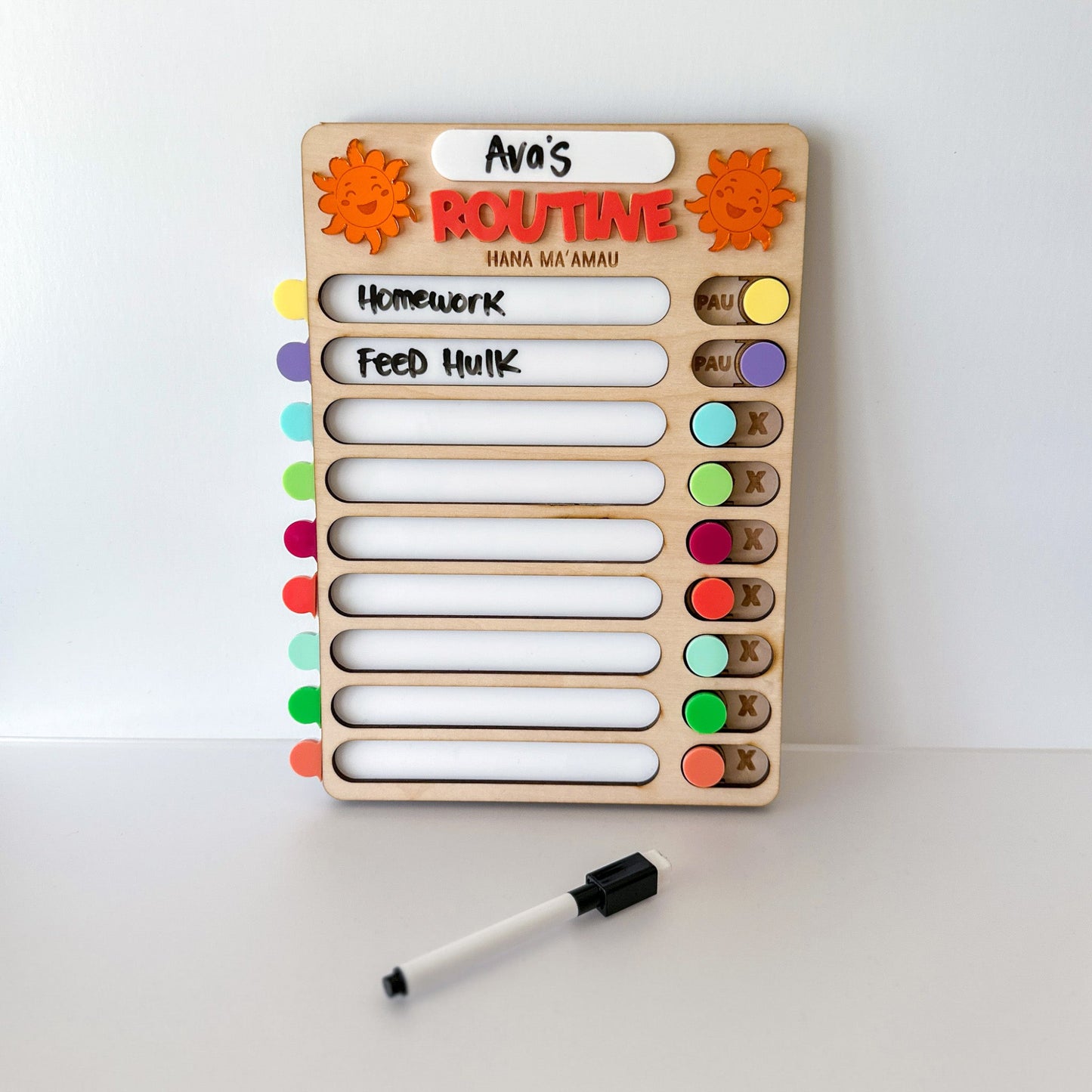 Wooden routine board with colorful labels and a marker on a white background