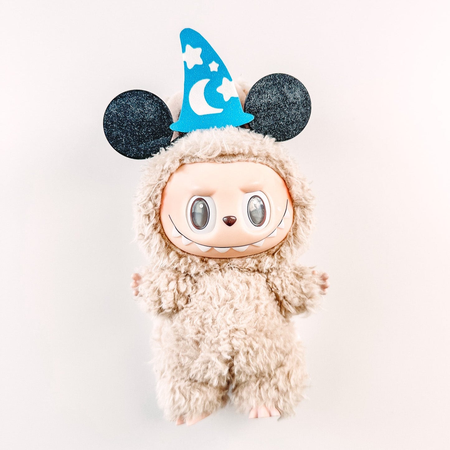 Plush toy with a wizard hat on a white background