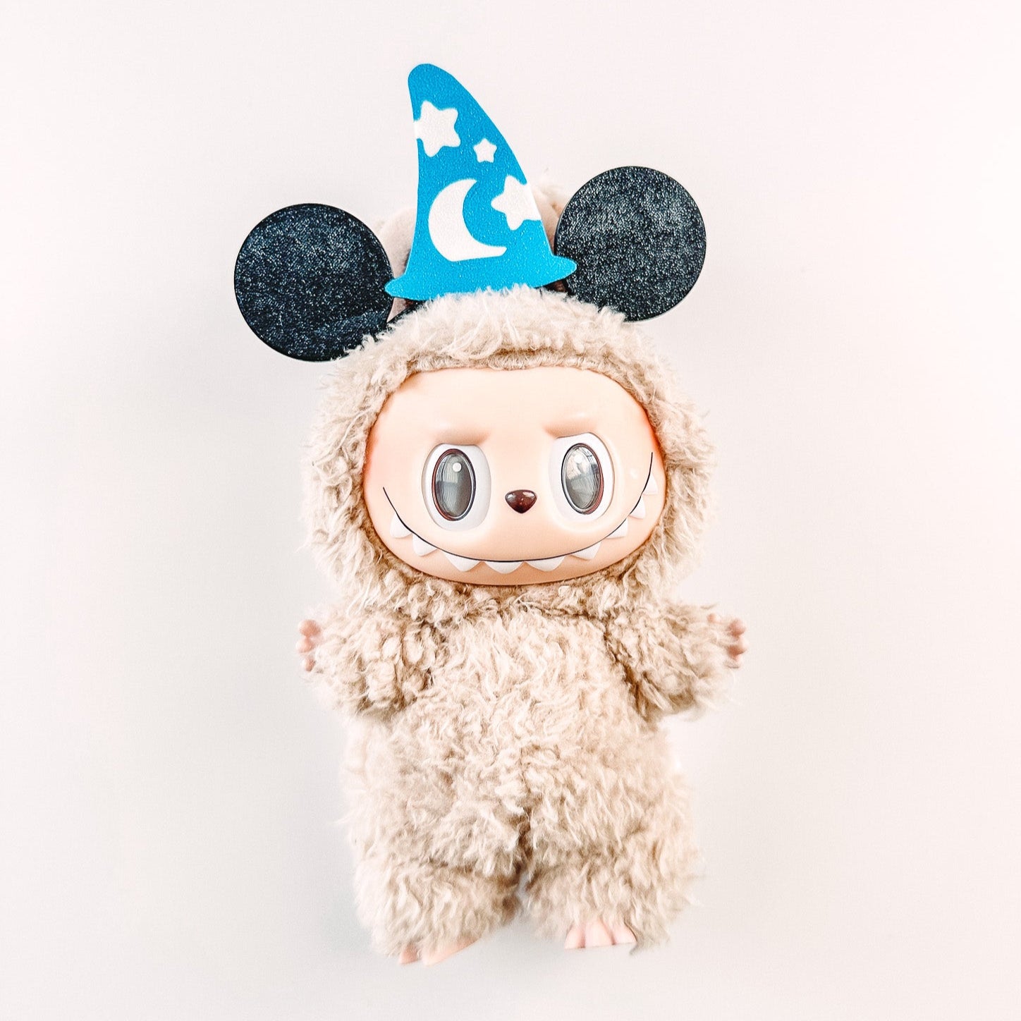 Plush toy with a wizard hat on a white background