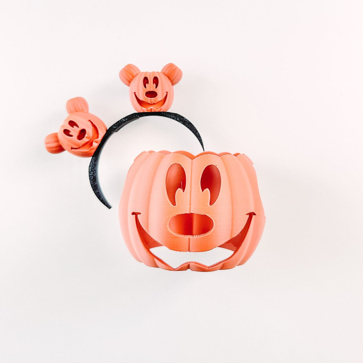 Set of Halloween-themed cookie cutters shaped like a pumpkin, ghost, and witch on a white background.